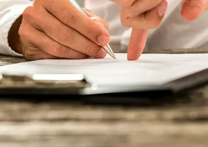 Closeup of male hand pointing where to sign a contract