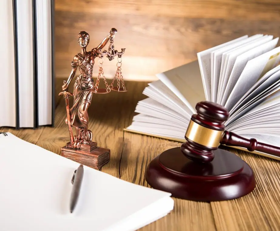 Lady of justice, gavel and books on wooden table
